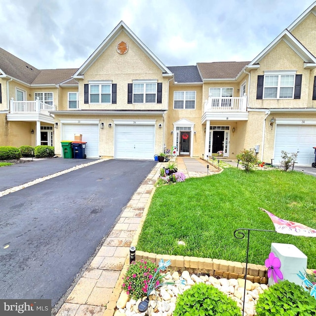 34 Springfield Cir, Middletown, DE 19709 - townhome / multi-family property with a garage, driveway, stucco siding, and a front yard