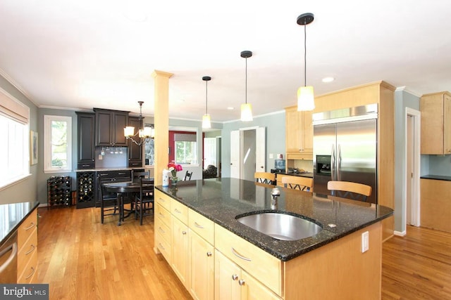11409 Flints Grove Ln, North Potomac, MD 20878 - kitchen with stainless steel built in fridge, a sink, plenty of natural light, crown molding, and light wood-style floors
