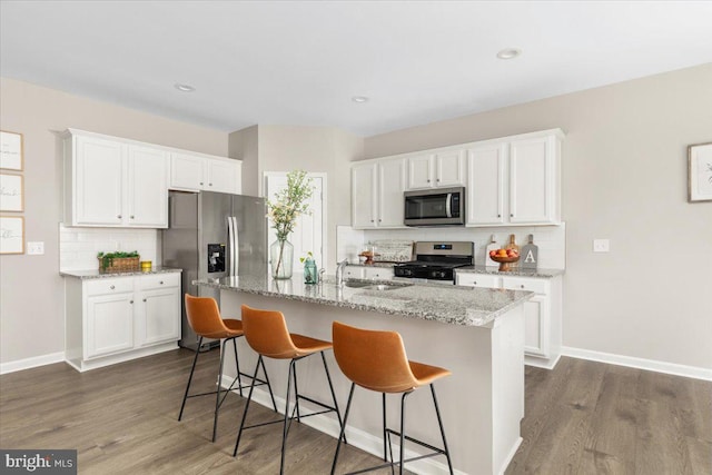 890 Shadows Dr, Front Royal, VA 22630 - kitchen with appliances with stainless steel finishes, decorative backsplash, white cabinetry, dark wood finished floors, and recessed lighting