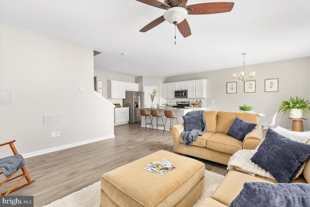 890 Shadows Dr, Front Royal, VA 22630 - living room featuring a chandelier, light wood-type flooring, and a ceiling fan