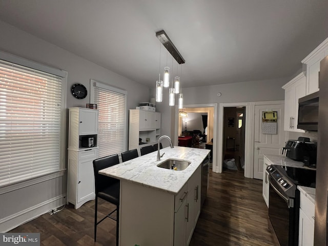 713 Juniper St, Quakertown, PA 18951 - kitchen featuring black appliances, a sink, dark wood finished floors, white cabinetry, and a breakfast bar area