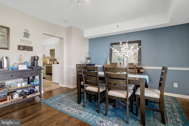 3713 S George Mason Dr Unit 713, Falls Church, VA 22041 - dining room featuring wood finished floors, baseboards, and a chandelier