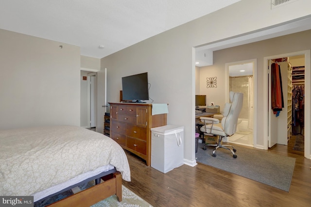 3713 S George Mason Dr Unit 713, Falls Church, VA 22041 - bedroom with wood finished floors, an office area, a walk in closet, and baseboards