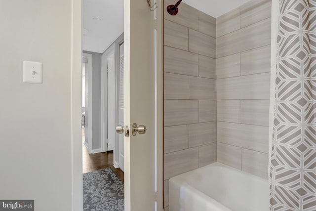 3713 S George Mason Dr Unit 713, Falls Church, VA 22041 - full bath featuring washtub / shower combination, baseboards, and wood finished floors