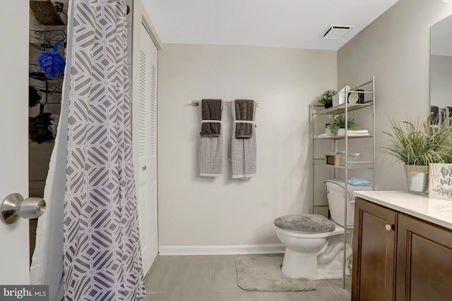 3713 S George Mason Dr Unit 713, Falls Church, VA 22041 - bathroom with a closet, toilet, vanity, baseboards, and tile patterned flooring