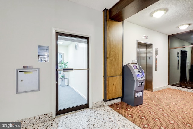 3713 S George Mason Dr Unit 713, Falls Church, VA 22041 - corridor featuring elevator, baseboards, a textured ceiling, and speckled floor