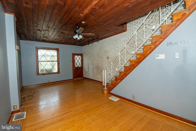 4225 Tackawanna St, Philadelphia, PA 19124 - entrance foyer featuring baseboards, wood finished floors, stairway, wooden ceiling, and brick wall