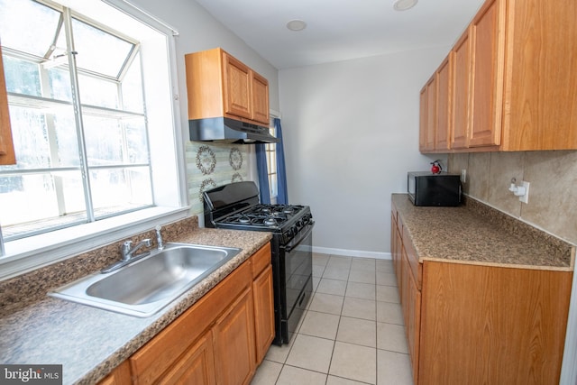 4225 Tackawanna St, Philadelphia, PA 19124 - kitchen featuring black appliances, under cabinet range hood, a sink, tasteful backsplash, and light tile patterned floors