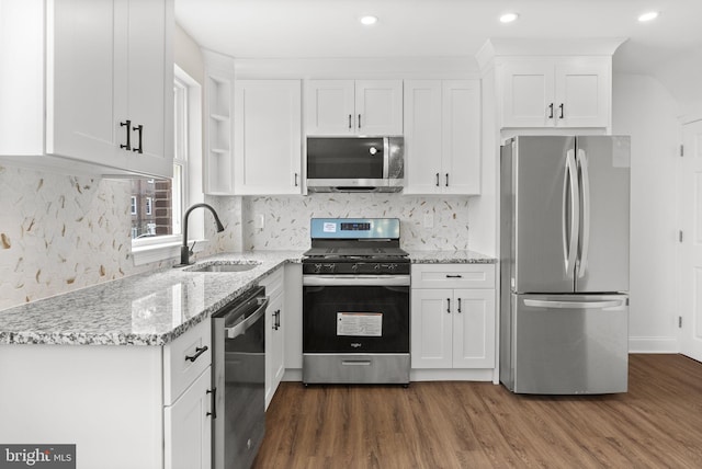 5021 Loretto Ave, Philadelphia, PA 19124 - kitchen with appliances with stainless steel finishes, a sink, white cabinets, dark wood finished floors, and light stone countertops
