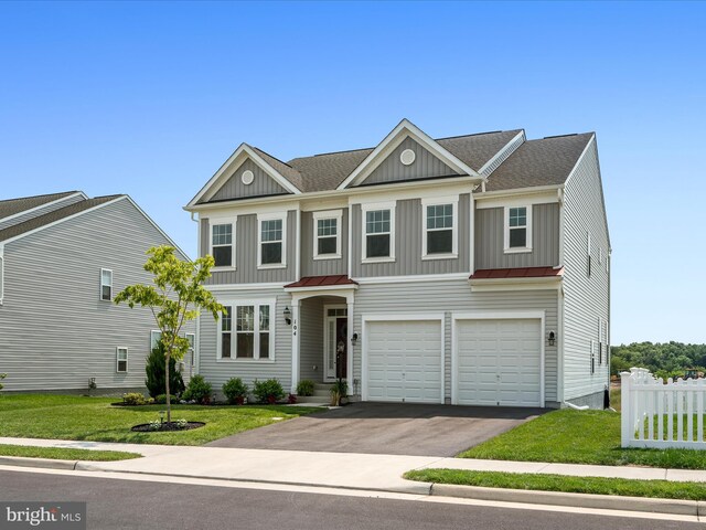 104 Barrister St, Stephenson, VA 22656 - view of front of house with board and batten siding, driveway, an attached garage, a standing seam roof, and metal roof