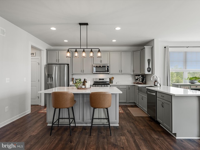 104 Barrister St, Stephenson, VA 22656 - kitchen featuring gray cabinetry, appliances with stainless steel finishes, a sink, tasteful backsplash, and a center island