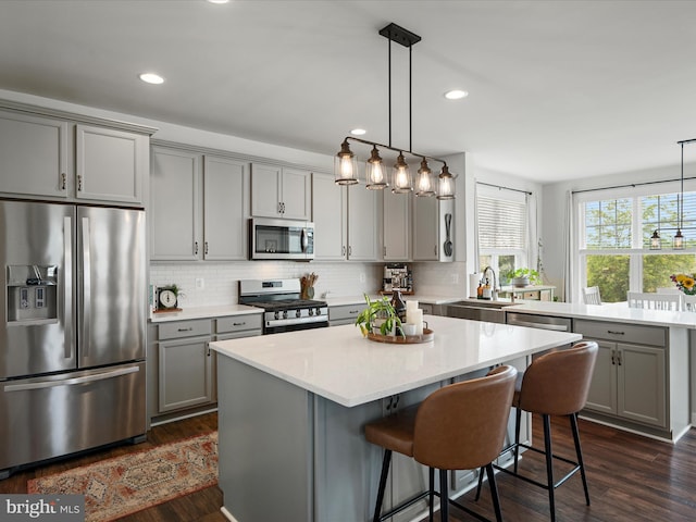 104 Barrister St, Stephenson, VA 22656 - kitchen with appliances with stainless steel finishes, gray cabinets, a sink, a center island, and decorative backsplash