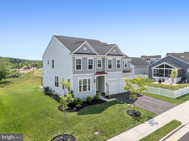 104 Barrister St, Stephenson, VA 22656 - view of front facade with asphalt driveway, an attached garage, a standing seam roof, central AC, and board and batten siding