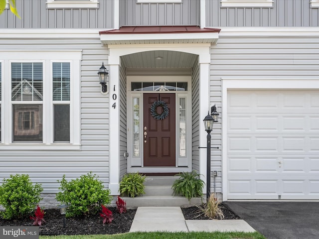 104 Barrister St, Stephenson, VA 22656 - doorway to property featuring board and batten siding and a garage
