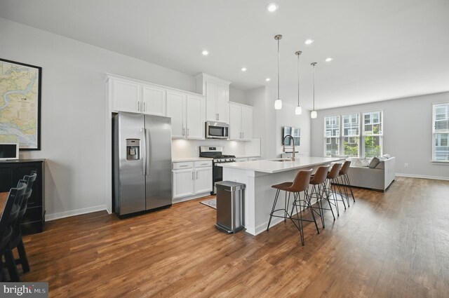 1763 Hickory Woods Rd, Dumfries, VA 22026 - kitchen featuring stainless steel appliances, wood finished floors, open floor plan, white cabinetry, and recessed lighting