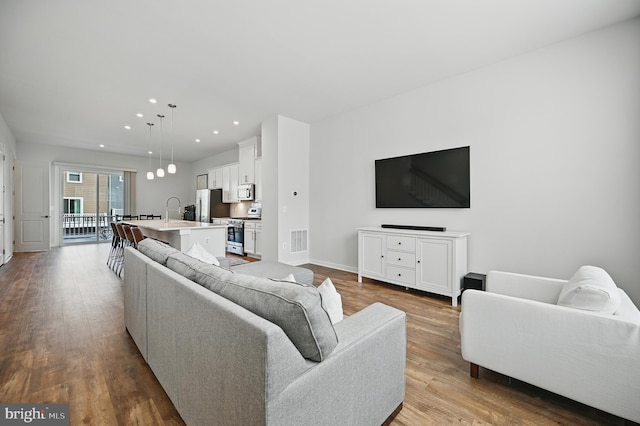 1763 Hickory Woods Rd, Dumfries, VA 22026 - living room with wood finished floors and recessed lighting