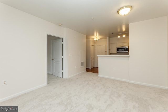 2204 Westcourt Ln Unit 201, Herndon, VA 20170 - unfurnished living room featuring light carpet and baseboards