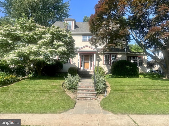 607 Harper Ave, Drexel Hill, PA 19026 - view of front facade with stucco siding, a front lawn, and roof with shingles