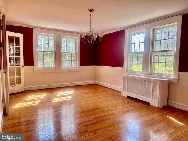 607 Harper Ave, Drexel Hill, PA 19026 - unfurnished room with radiator heating unit, healthy amount of natural light, a chandelier, ornamental molding, and wood finished floors