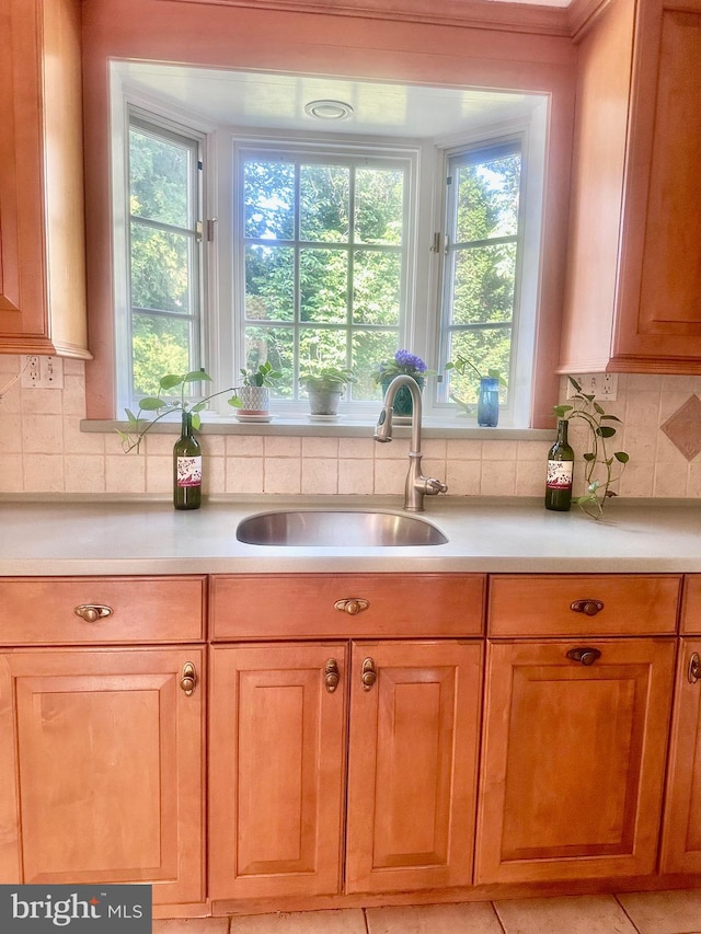607 Harper Ave, Drexel Hill, PA 19026 - kitchen featuring a sink, light countertops, and plenty of natural light