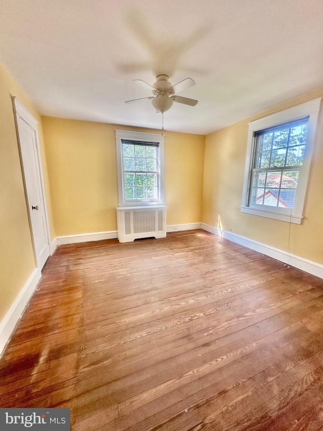 607 Harper Ave, Drexel Hill, PA 19026 - empty room with radiator heating unit, wood finished floors, a ceiling fan, and baseboards