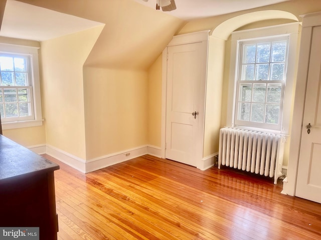 607 Harper Ave, Drexel Hill, PA 19026 - additional living space with radiator heating unit, light wood-style flooring, vaulted ceiling, baseboards, and a ceiling fan
