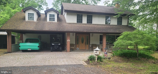16002 Letcher Rd, Brandywine, MD 20613 - view of front facade with decorative driveway, roof with shingles, an attached carport, and stucco siding