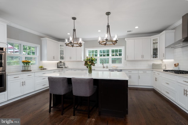 58 Haas Rd, Basking Ridge, NJ 07920 - kitchen with wall chimney exhaust hood, ornamental molding, a chandelier, appliances with stainless steel finishes, and backsplash