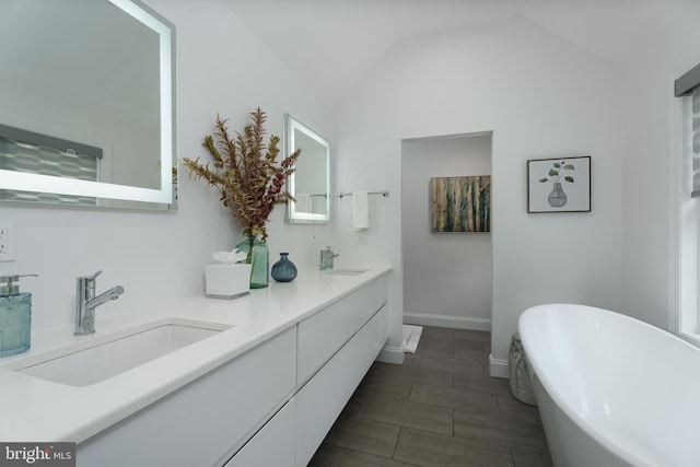 58 Haas Rd, Basking Ridge, NJ 07920 - bathroom featuring a freestanding bath, double vanity, baseboards, and vaulted ceiling