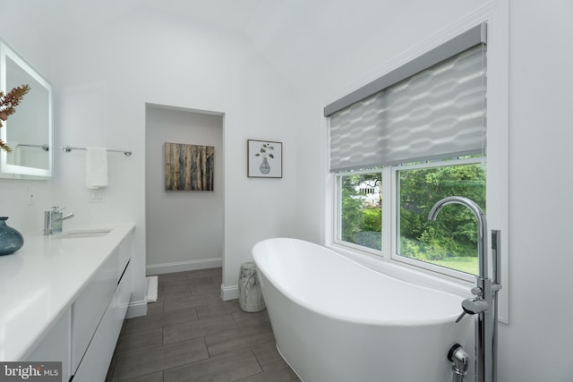 58 Haas Rd, Basking Ridge, NJ 07920 - bathroom with a freestanding bath, double vanity, lofted ceiling, and baseboards