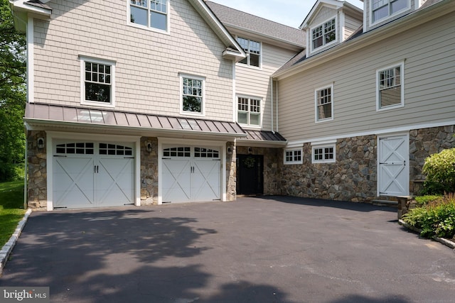 58 Haas Rd, Basking Ridge, NJ 07920 - view of side of property with stone siding, driveway, a garage, and a standing seam roof