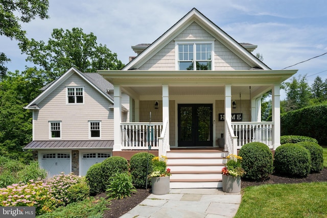 58 Haas Rd, Basking Ridge, NJ 07920 - view of front facade with a porch, a garage, french doors, and a standing seam roof