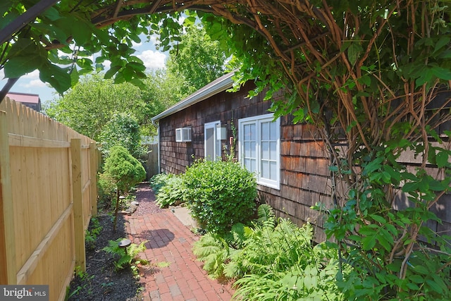 726 Forest Grove Rd, Wycombe, PA 18980 - view of side of home with an AC wall unit and a patio area