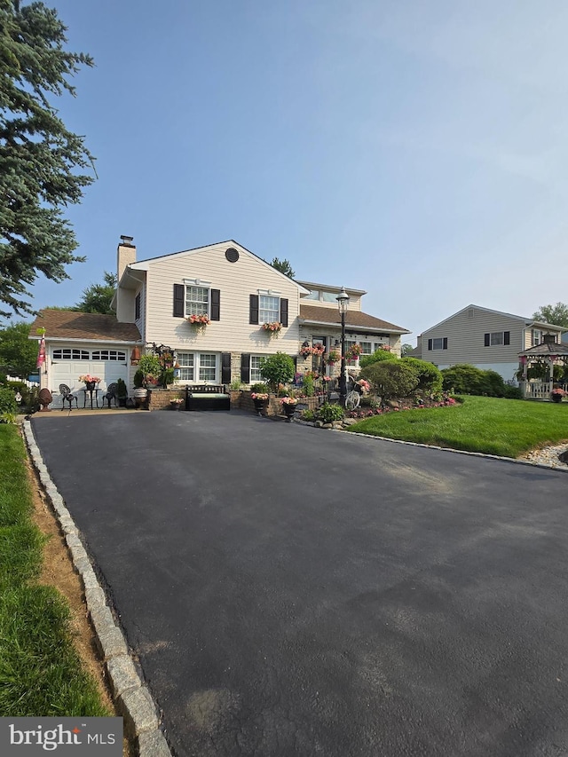 1397 Dennis Rd, Southampton, PA 18966 - view of front of house with a chimney, driveway, and a front yard