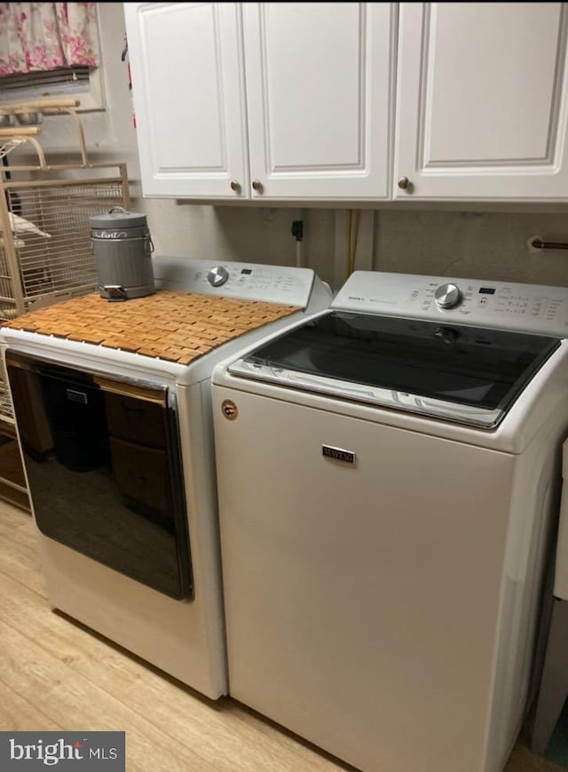 1397 Dennis Rd, Southampton, PA 18966 - laundry room featuring separate washer and dryer, light wood-style floors, and cabinet space