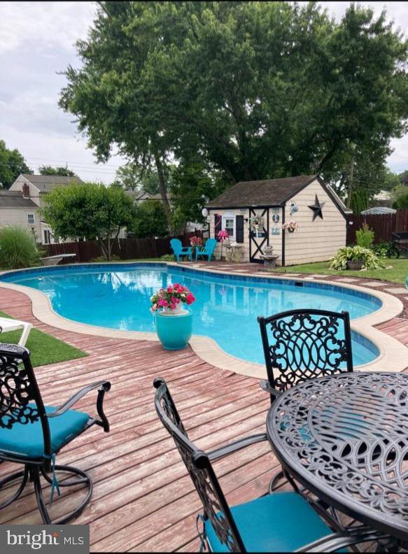 1397 Dennis Rd, Southampton, PA 18966 - view of pool featuring a fenced backyard, a wooden deck, and an outbuilding
