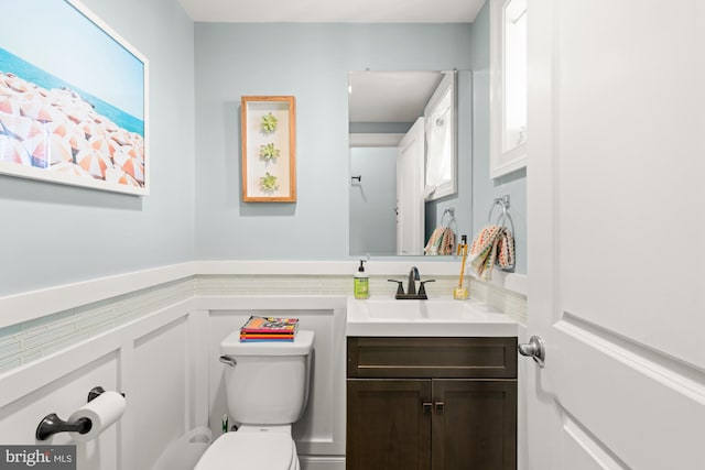 206 E Randall St, Baltimore, MD 21230 - bathroom featuring toilet, vanity, and wainscoting