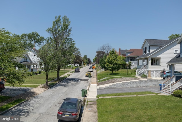 2912 Bauernwood Ave, Baltimore, MD 21234 - view of asphalt street featuring a residential view, sidewalks, curbs, and stairs