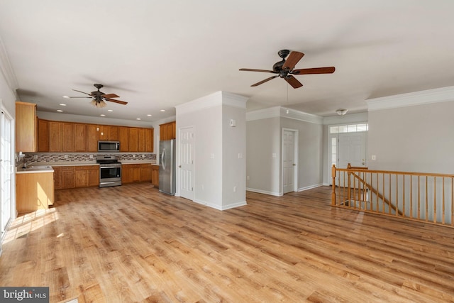 35510 Somerset Ridge Rd, Locust Grove, VA 22508 - kitchen featuring appliances with stainless steel finishes, a ceiling fan, light wood-type flooring, backsplash, and brown cabinetry
