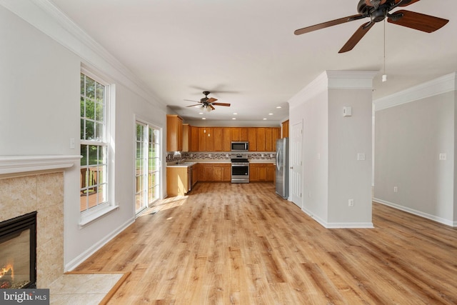35510 Somerset Ridge Rd, Locust Grove, VA 22508 - kitchen featuring stainless steel appliances, ceiling fan, ornamental molding, brown cabinetry, and light countertops