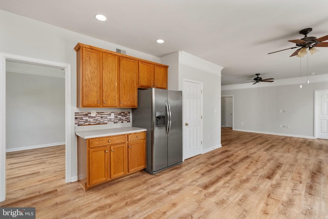 35510 Somerset Ridge Rd, Locust Grove, VA 22508 - kitchen with stainless steel fridge, a ceiling fan, light countertops, brown cabinets, and tasteful backsplash