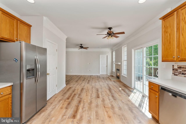 35510 Somerset Ridge Rd, Locust Grove, VA 22508 - kitchen featuring appliances with stainless steel finishes, brown cabinets, light countertops, a ceiling fan, and crown molding