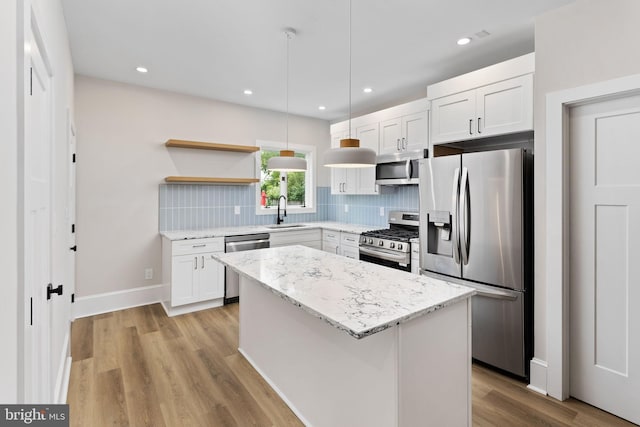 26 Jefferson Rd, Princeton, NJ 08540 - kitchen with appliances with stainless steel finishes, open shelves, backsplash, white cabinets, and a center island