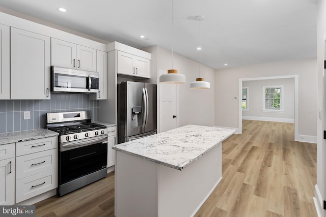 26 Jefferson Rd, Princeton, NJ 08540 - kitchen with appliances with stainless steel finishes, a center island, light wood-style floors, tasteful backsplash, and recessed lighting