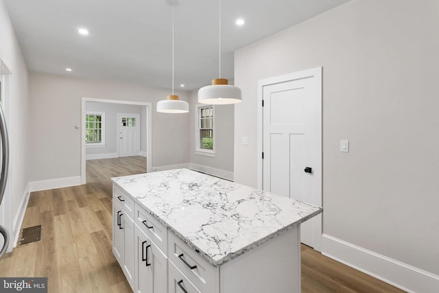 26 Jefferson Rd, Princeton, NJ 08540 - kitchen with light wood-style floors, white cabinets, a kitchen island, pendant lighting, and baseboards