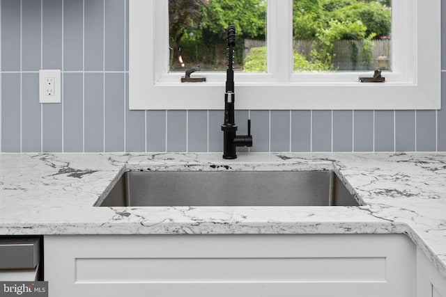 26 Jefferson Rd, Princeton, NJ 08540 - kitchen view of a sink, white cabinetry, and light stone countertops