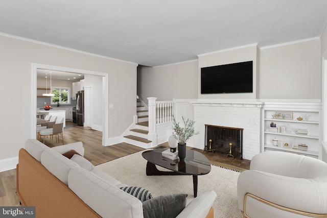 26 Jefferson Rd, Princeton, NJ 08540 - living room with crown molding, wood finished floors, a fireplace, stairway, and baseboards