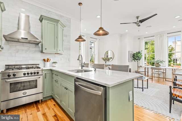 1235 S St NW Unit 1, Washington, DC 20009 - kitchen featuring green cabinetry, appliances with stainless steel finishes, wall chimney exhaust hood, a sink, and recessed lighting