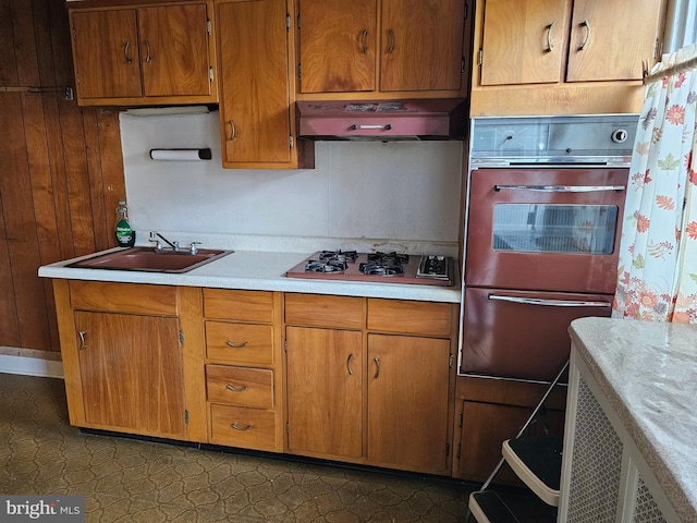 1943 W Sparks St, Philadelphia, PA 19141 - kitchen with wall oven, under cabinet range hood, a warming drawer, gas stovetop, and light countertops