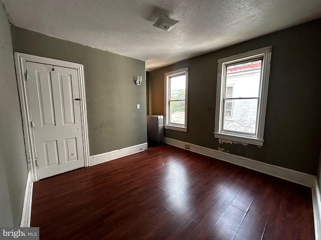 342 S 4th St, Reading, PA 19602 - unfurnished bedroom with a textured ceiling, wood finished floors, baseboards, and a closet